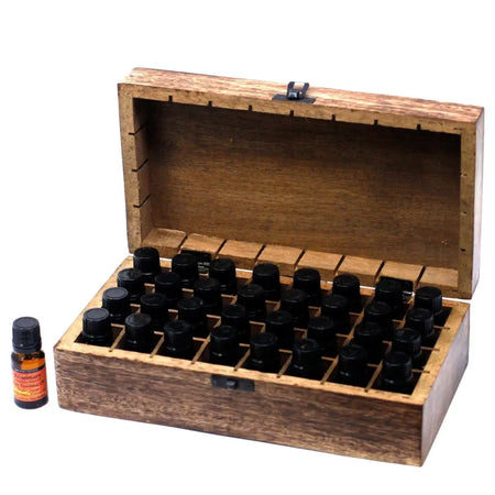 A carved mango wood aromatherapy box with hinged lid holds 36 black-capped 10ml bottles arranged neatly in rows