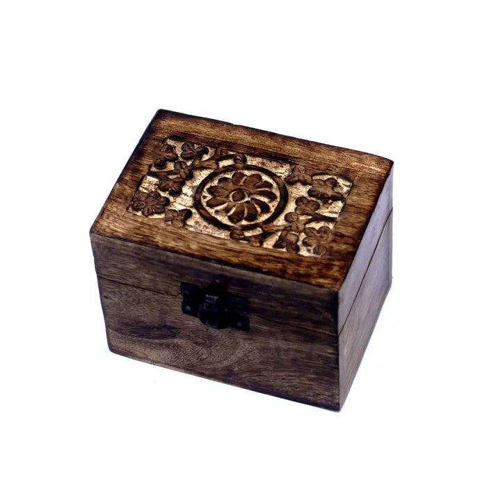 A dark brown carved mango wood aromatherapy box with floral lid and black clasp holds six essential oils