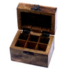 A rustic carved mango wood aromatherapy box with dark brown finish and black hinges holds six essential oils