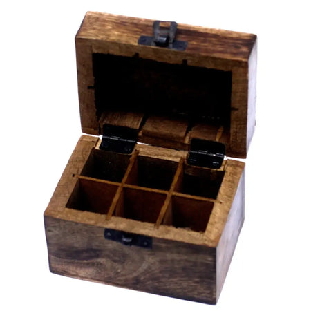 A rustic carved mango wood aromatherapy box with dark brown finish and black hinges holds six essential oils