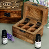 A carved mango wood aromatherapy box with six compartments and black metal hinges for essential oils storage