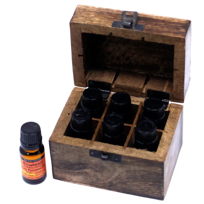 A carved mango wood aromatherapy box with metal latch holding six black-capped essential oils bottles