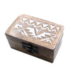 A rectangular mango wood trinket box with a natural brown finish and white carved slavic geometric design on the lid