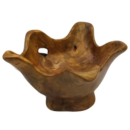 A small round teak root bowl with natural grain patterns and a rustic hand carved leaf shape design