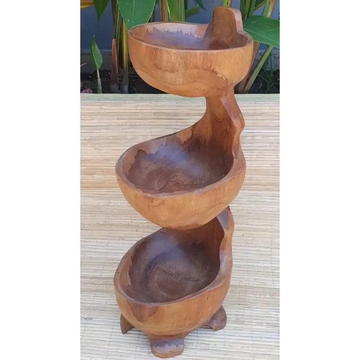 Hand carved wooden spiral tiered bowl with three rounded teak compartments and a natural wood finish