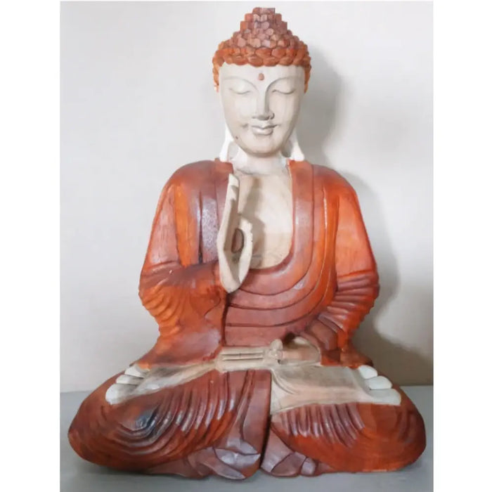 A carved wood buddha statue in reddish-brown suar wood with white accents showing teaching transmission pose