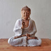 Hand carved suar wood buddha statue with serene expression, whitewashed robes, and ushnisha in natural wood tones, 40cm tall