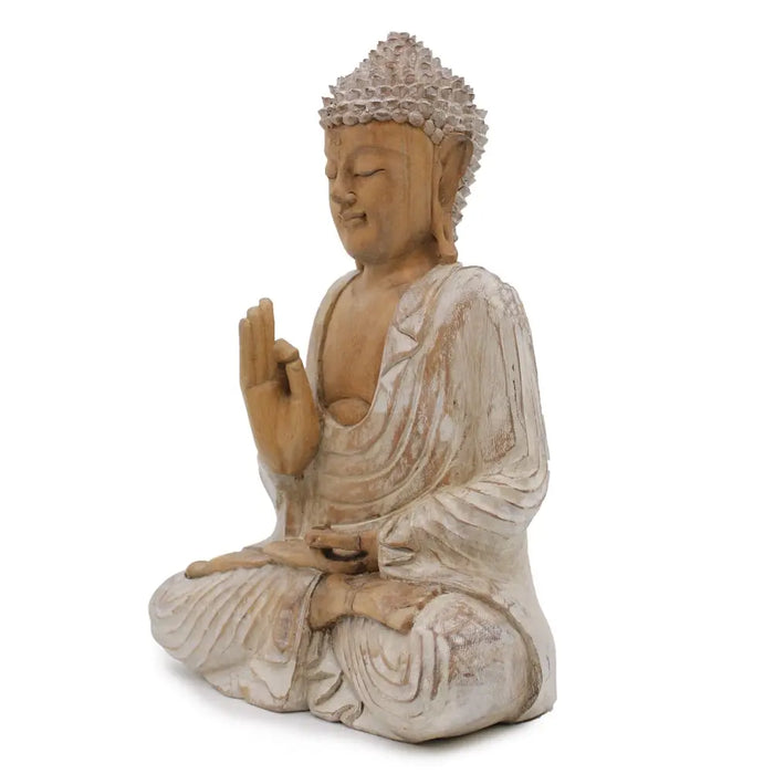 A serene carved wood buddha statue in whitewash with intricate robes and spiky headpiece made from suar wood 40cm tall