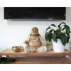 A carved wood happy buddha statue with a whitewash beige finish made from suar wood and detailed robes with pearl necklaces