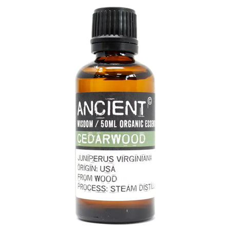 A 50ml amber glass bottle of cedarwood essential oil with a black cap showing its botanical origin label