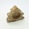 Weathered bronze metal tealight holder with star-shaped design and central circle for a ceramic christmas tree setup