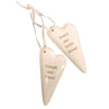 Cream-colored ceramic heart hanging ornaments with engraved motivational phrases and satin ribbon loops