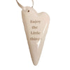 Cream-colored ceramic heart hanging ornament with enjoy the little things engraved in soft gray tone