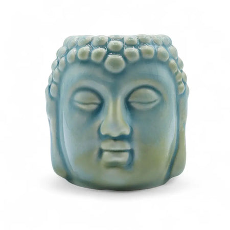 A serene pastel blue ceramic oil burner shaped like a detailed buddha head with a textured bead crown