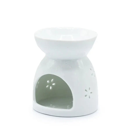 White ceramic oil burner with a glossy finish and star-shaped cutouts for use with essential oils