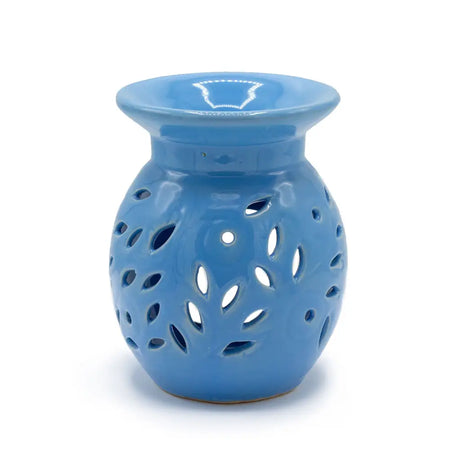 Blue ceramic oil burner with leaf-shaped cutouts and a glossy finish for use as a floral oil burner