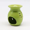 A glossy lime green ceramic oil burner with flared top and leaf-shaped cutouts on the side