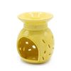 Yellow ceramic oil burner with flared top and decorative perforations for floral scented oils