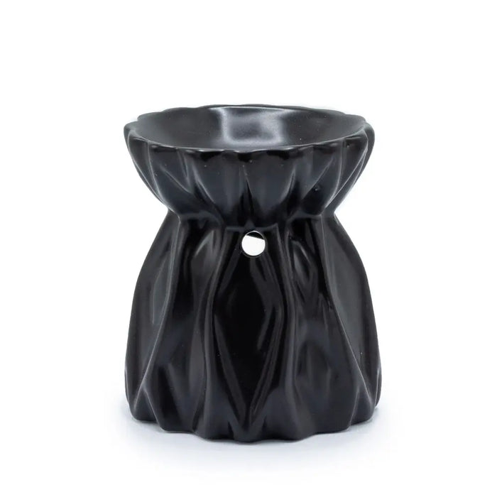 Black ceramic oil burner with a fluted petal top and pleated body for use as an oil burner decoration