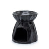 Black ceramic oil burner with fluted petal rim and textured body designed as a geometric oil burner