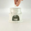White ceramic oil burner with rose design and built-in tea light holder for scented oils and wax melts