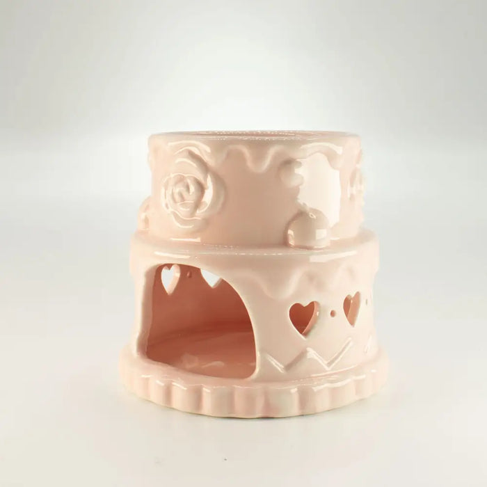 Pastel pink ceramic oil burner with rose and heart cutouts designed as a terrarium for oil burners