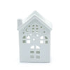 White ceramic oil burner shaped like a house with cut-out star and moon patterns for house-warming decor