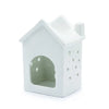 White ceramic oil burner shaped like a house with star cutouts and an arched doorway for home use