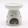 White ceramic oil burner with star-shaped cutouts and glossy finish for use with oil burners in aromatherapy
