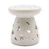 White ceramic oil burner with star and moon cutouts designed for use as an oil burner decoration