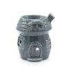 Gray ceramic oil burner shaped like a mushroom house with detailed roof windows and door design