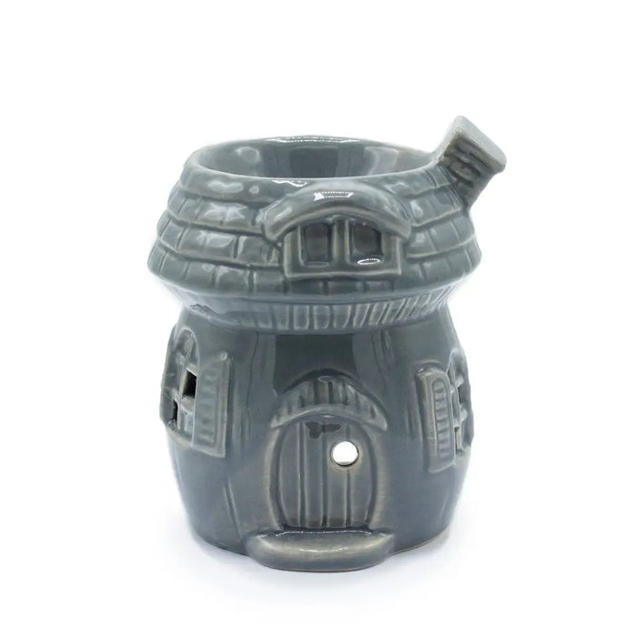 Gray ceramic oil burner shaped like a mushroom house with detailed roof windows and door design