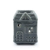 Gray ceramic oil burner shaped like a house with detailed windows and an arched doorway for home use