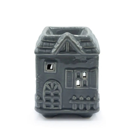 Gray ceramic oil burner shaped like a house with detailed windows and an arched doorway for home use
