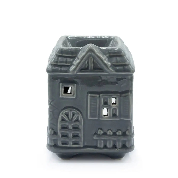 Gray ceramic oil burner shaped like a house with detailed windows and an arched doorway for home use