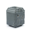 Gray ceramic oil burner shaped like a house with detailed windows roof and door design for oil diffusion