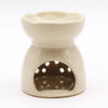 Cream-colored ceramic oil burner with flower-shaped top and circular cutouts for aroma diffusion in ivory finish