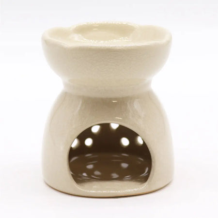 Cream-colored ceramic oil burner with flower-shaped top and circular cutouts for aroma diffusion in ivory finish
