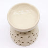 Cream-colored ceramic oil burner tree of life ivory with rounded rim and circular perforations around its base