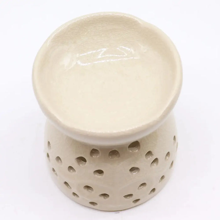 Cream-colored ceramic oil burner tree of life ivory with rounded rim and circular perforations around its base