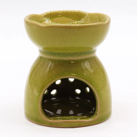 A lime green ceramic oil burner with a crackled glaze and scalloped rim designed for essential oils use