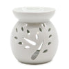 White ceramic oil burner with leaf-shaped cutouts designed as a tree for use with oil burners