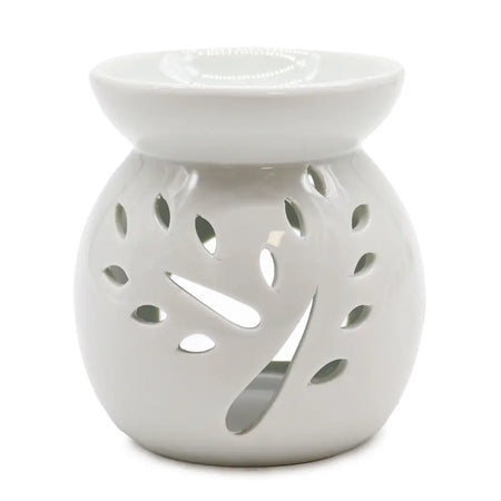 White ceramic oil burner with leaf-shaped cutouts designed as a tree for use with oil burners