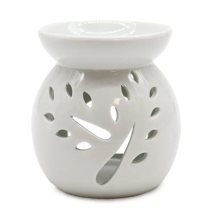 White ceramic oil burner with leaf-shaped cutouts designed as a tree for use with oil burners