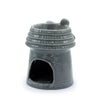 Gray ceramic oil burner shaped like a beehive with textured brick patterns and a small bee figurine on top