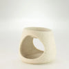 Cream-colored speckled ceramic zen pebble oil burner with an open circular cutout for essential oils and wax melts