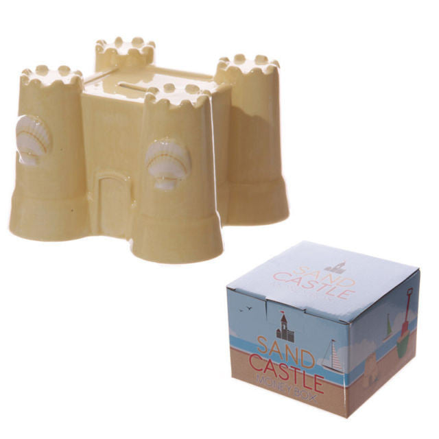 Beige ceramic sand castle money box with molded towers and coin slot for saving coins and small change