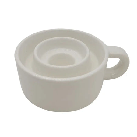 White ceramic candle holder cup with handle and circular indentations designed for tealight and dinner candles