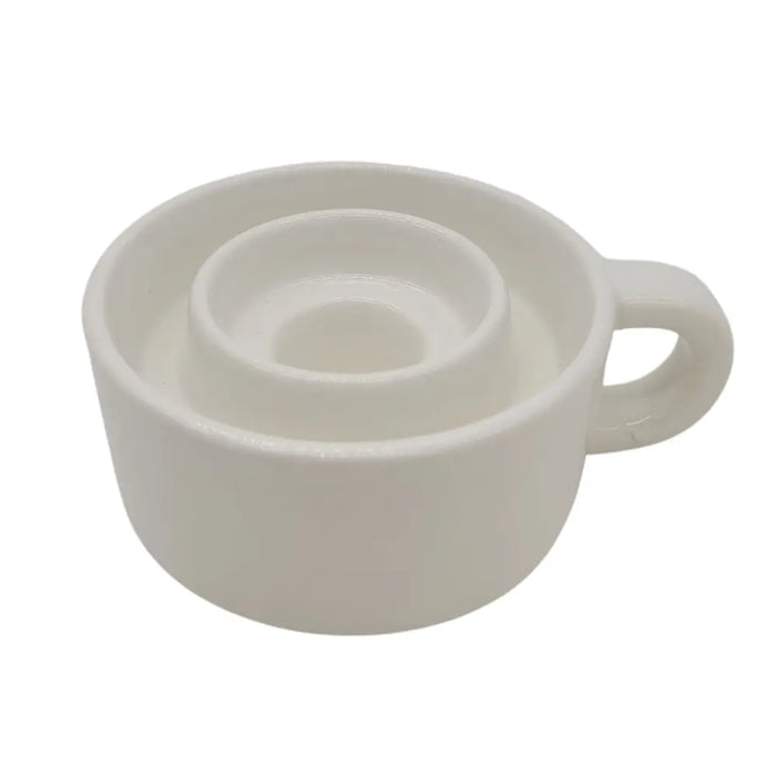 White ceramic candle holder cup with handle and circular indentations designed for tealight and dinner candles