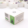 White cardboard box with green accents and black text for chakra crystal candle featuring a meditating figure silhouette